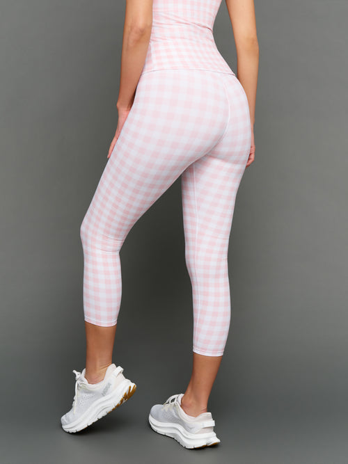 Model wears Gingham Capri Leggings on a grey background