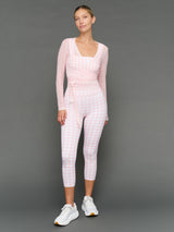 Model wears a Gingham outfit on a grey background