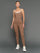 Model is wearing double layer melt tank caribou white, full body front view.