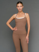 Model is wearing double layer melt tank caribou white, front upper body view.