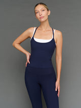 Model is wearing double layer melt tank navy blazer white, front upper body close-up.