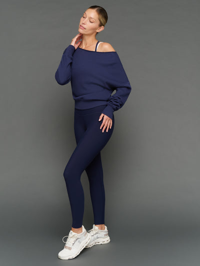 Model is wearing double layer melt tank navy blazer white with matching leggings and pullover, full body styled look.