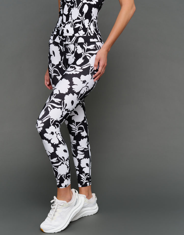 Model is wearing melt high-waisted legging floral print, front angled view.