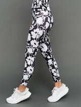 Model is wearing melt high-waisted legging floral print, side view.
