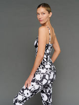 Model is wearing melt ruched tank floral print, side view.