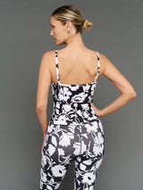 Model is wearing melt ruched tank floral print, back view.