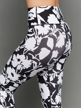 Model is wearing melt high-waisted legging floral print, back close-up.