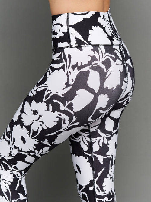 Model is wearing melt high-waisted legging floral print, back close-up.