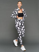 Model is wearing melt high-waisted legging floral print styled with jacket, full body view.