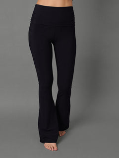 Model wears black bootcut leggings against a grey background
