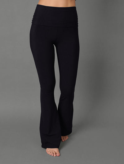 Model wears black bootcut leggings against a grey background