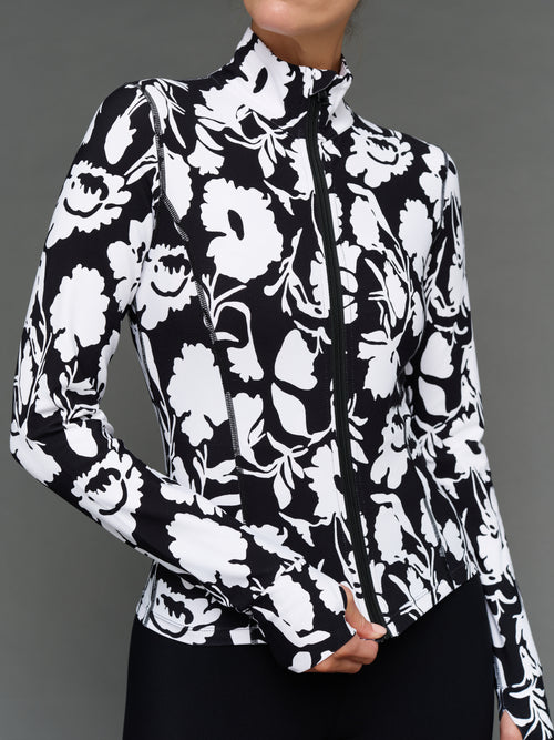 Model is wearing melt full zip jacket floral print, close-up zipper detail.