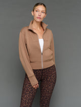 Model is wearing interlock full zip jacket caribou with printed leggings, front view.