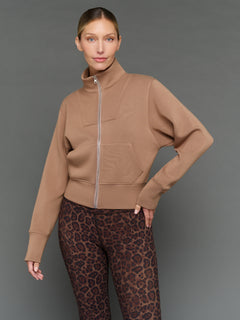 Model is wearing interlock full zip jacket caribou, front zip-up styling.
