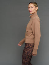 Model is wearing interlock full zip jacket caribou, side profile view.