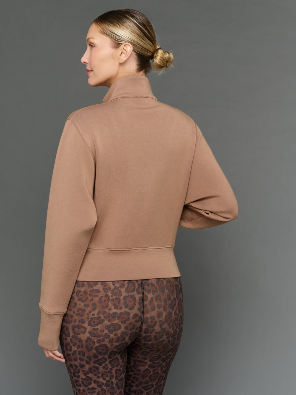Model is wearing interlock full zip jacket caribou, back view.