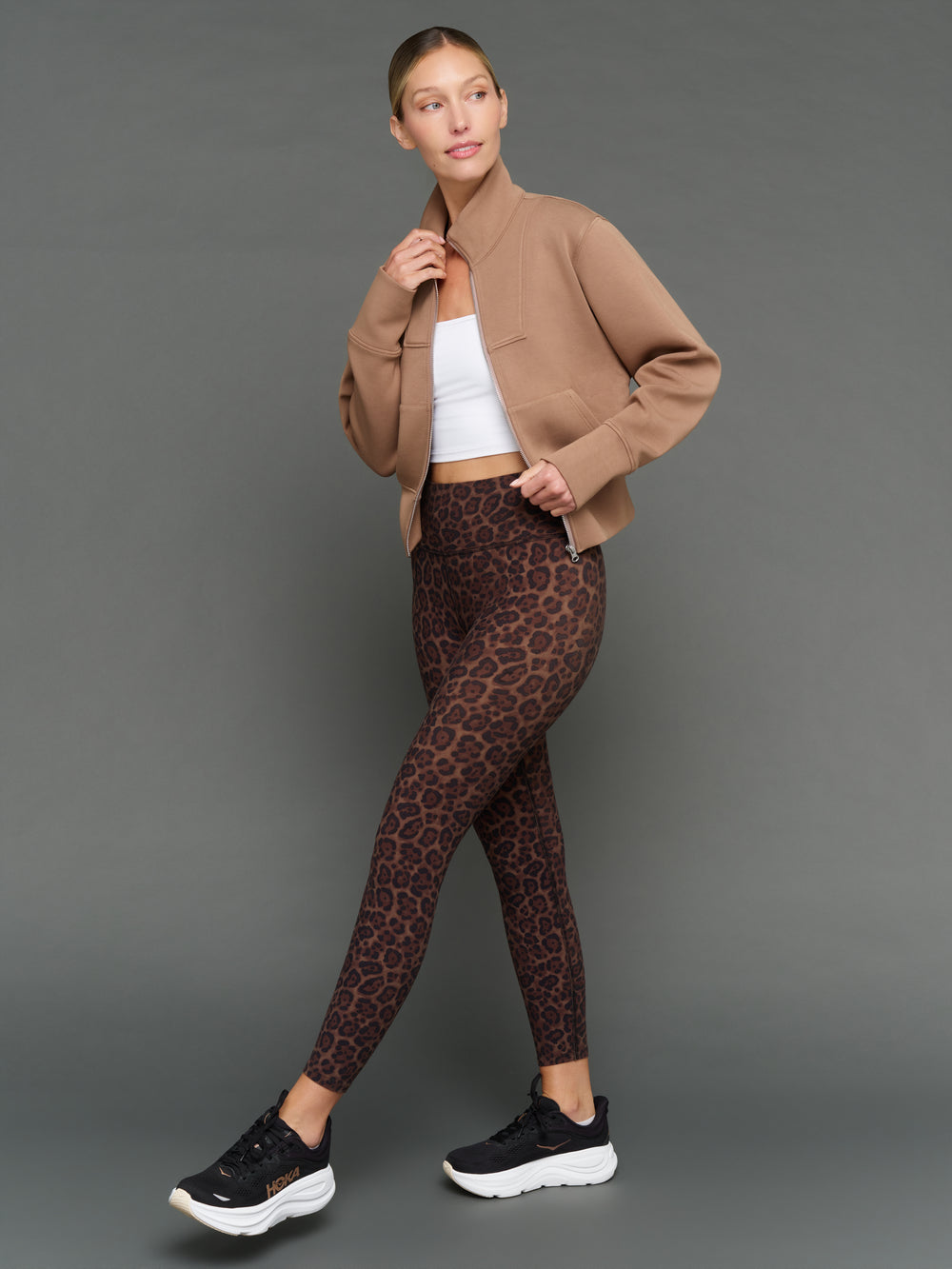 Model is wearing interlock full zip jacket caribou with leggings, full body styled look.