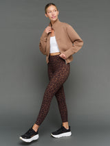 Model is wearing interlock full zip jacket caribou with leggings, full body styled look.