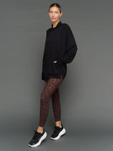 Model is wearing interlock mock neck pullover black, front three-quarter view.