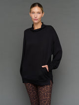 Model is wearing interlock mock neck pullover black, front close-up view.