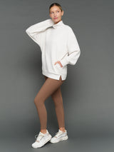 Model is wearing interlock mock neck pullover moonbeam heather, front full body view.