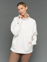 Model is wearing interlock mock neck pullover moonbeam heather, front view.