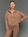 Model is wearing interlock half zip pullover caribou, front upper body view.