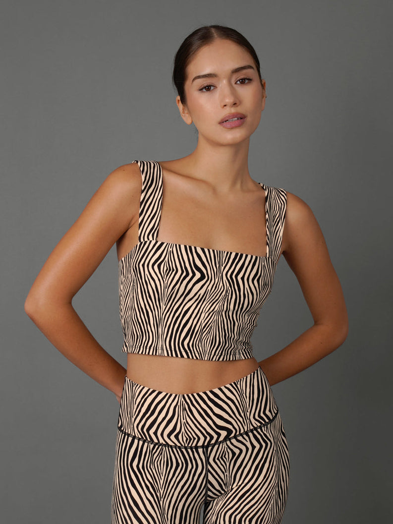 Model wears a zebra print square neck bra top against a grey background