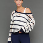 Model is wearing wide neck open knit sweater white navy, front close-up view.