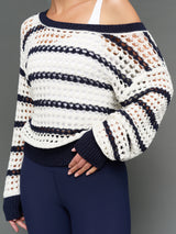 Model is wearing wide neck open knit sweater white navy, texture close-up view.