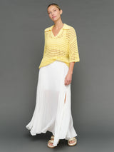 Model is wearing open knit polo sweater pale banana, front full body view.