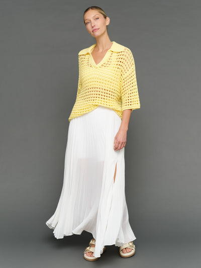 Model is wearing open knit polo sweater pale banana, front full body view.