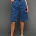Model is wearing chambray bermuda short dark wash, front view.