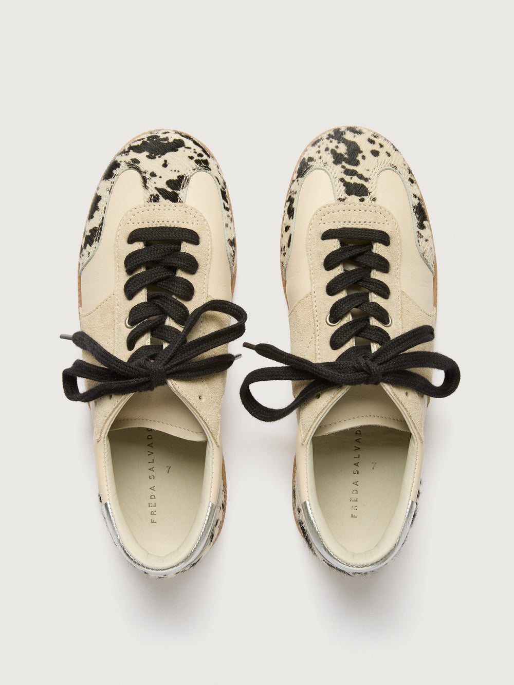 Cowhair low top neutral sneaker with black laces. 