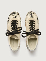 Cowhair low top neutral sneaker with black laces. 